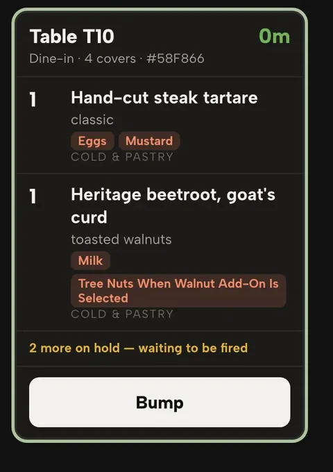 A kitchen display ticket for table T10: two starters with allergen labels, two more dishes on hold waiting to be fired, and the Bump button